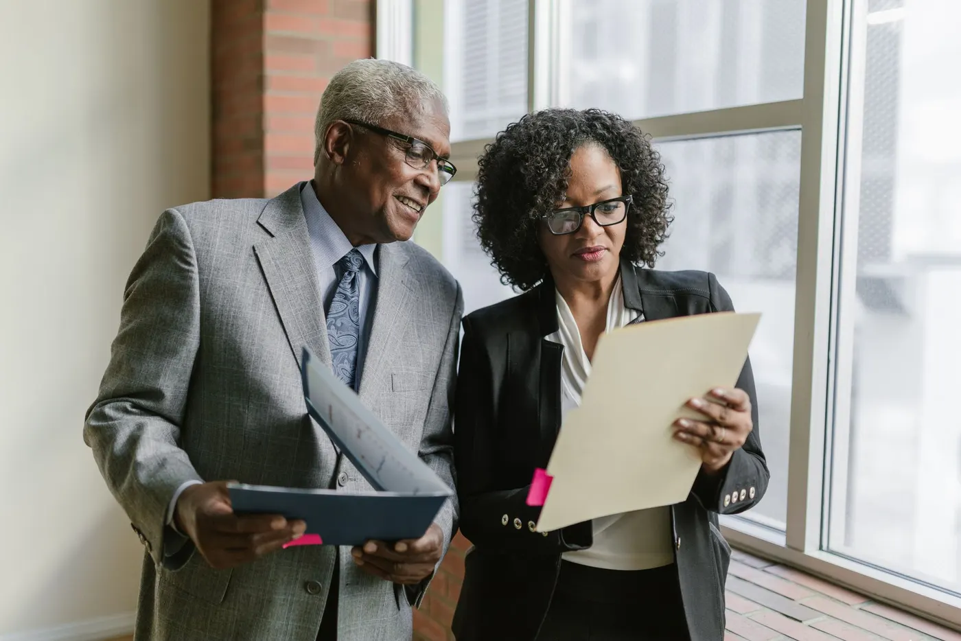 Two financial advisers reviewing a client portfolio together